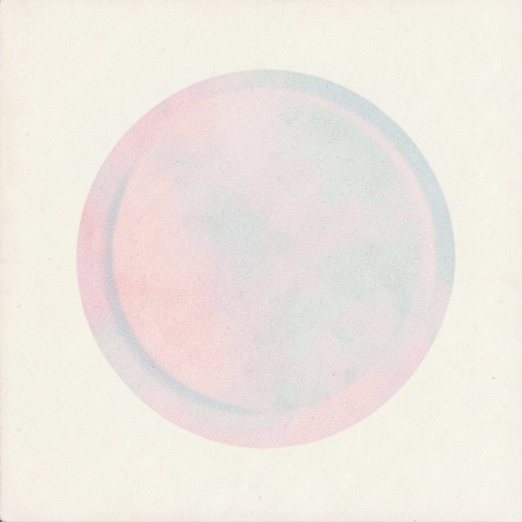 A grainy analog film photograph of a simple circular emblem on a cream background, with muted pastel pink and pale blue tones, soft and understated.